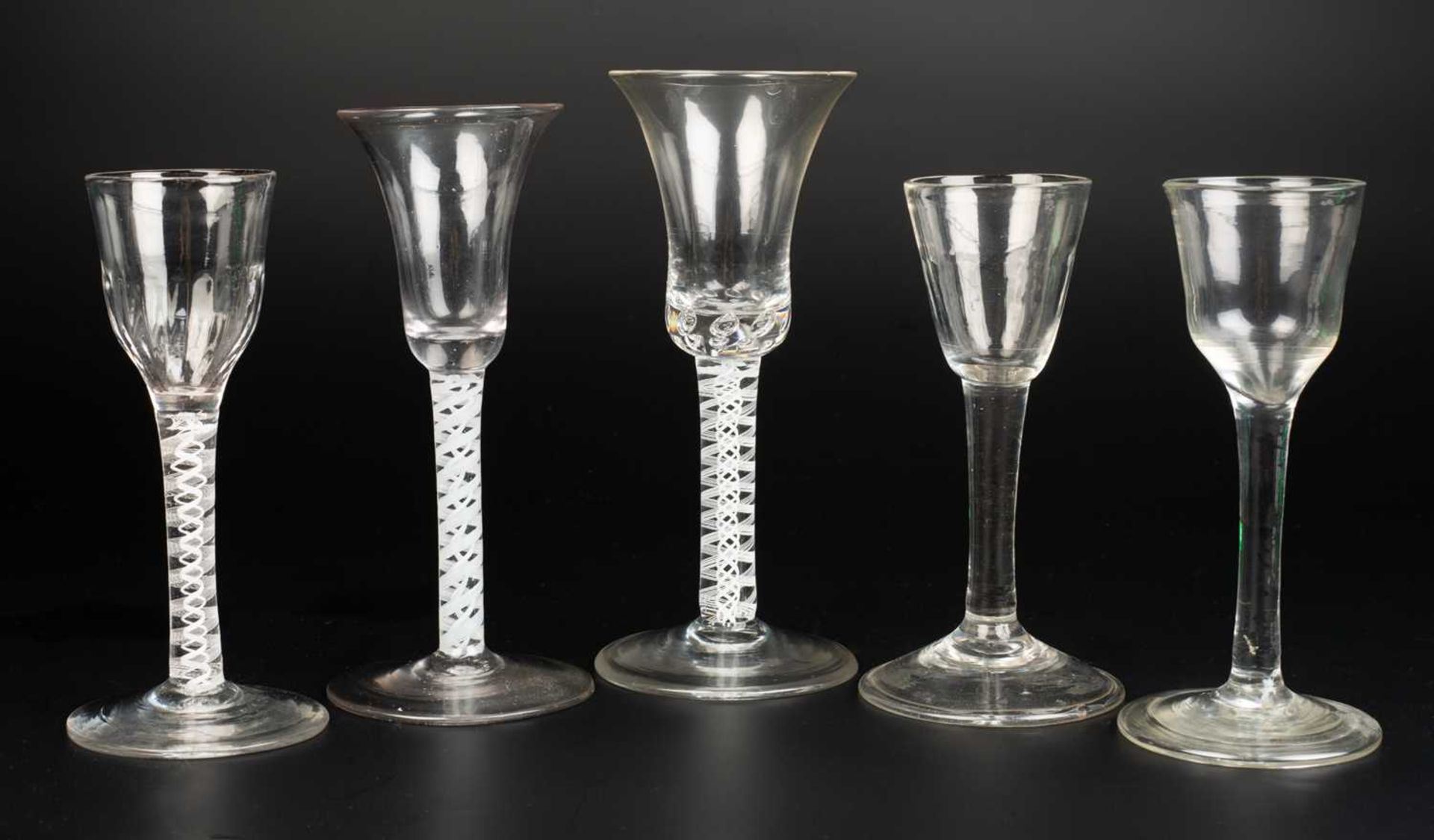 A collection of five antique wine glasses