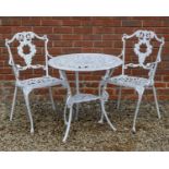 A white painted cast aluminium circular table and a pair of chairs