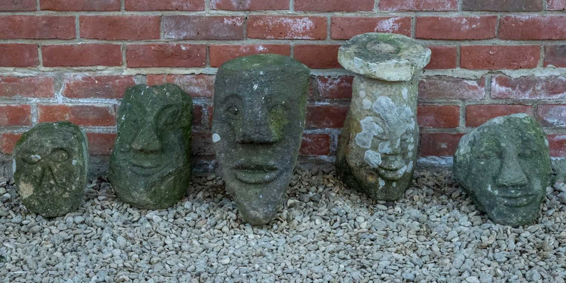 Five roughly carved stone heads