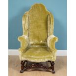 A 19th century crushed sage green velvet wingback armchair