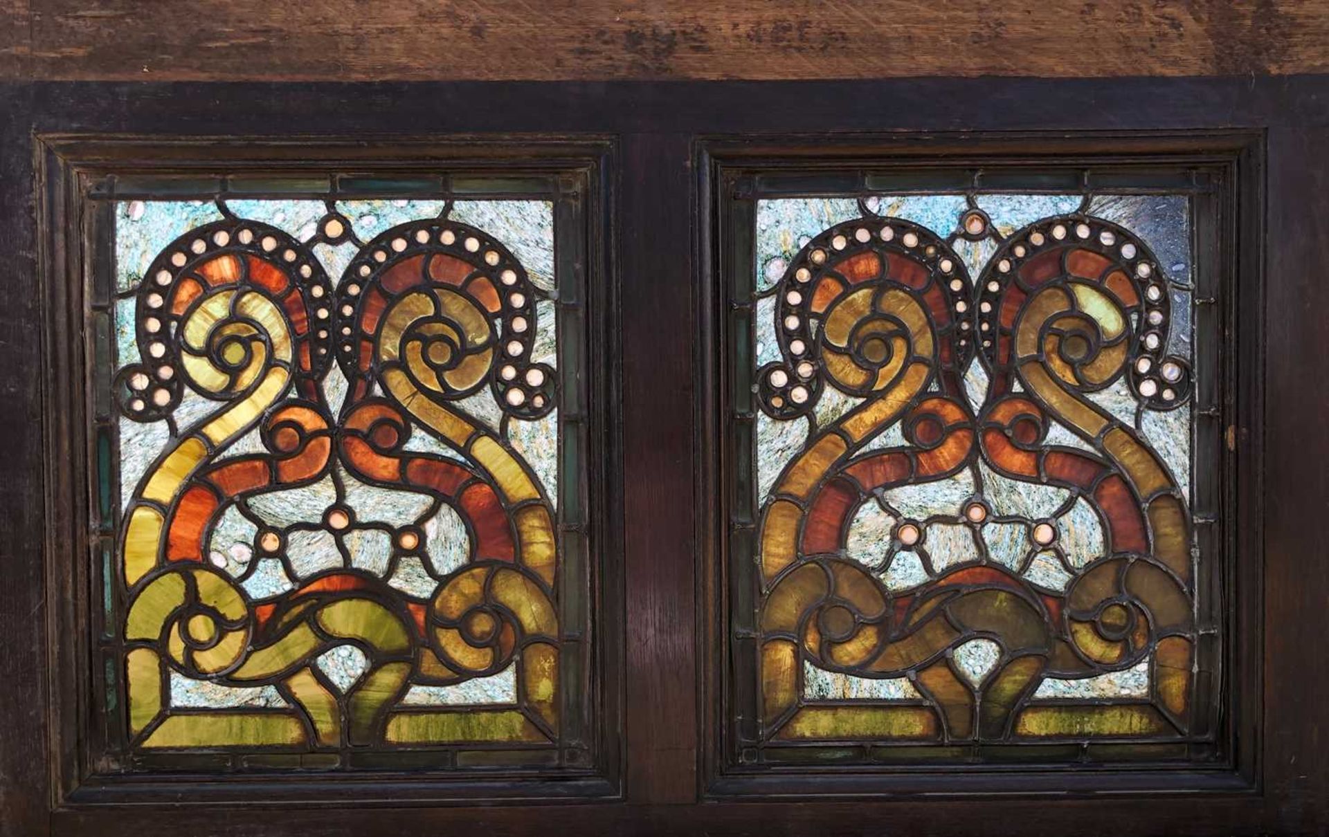 An oak framed stained glass panel