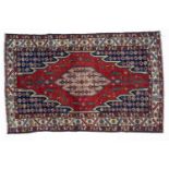 An antique Mazlagan red and blue ground rug