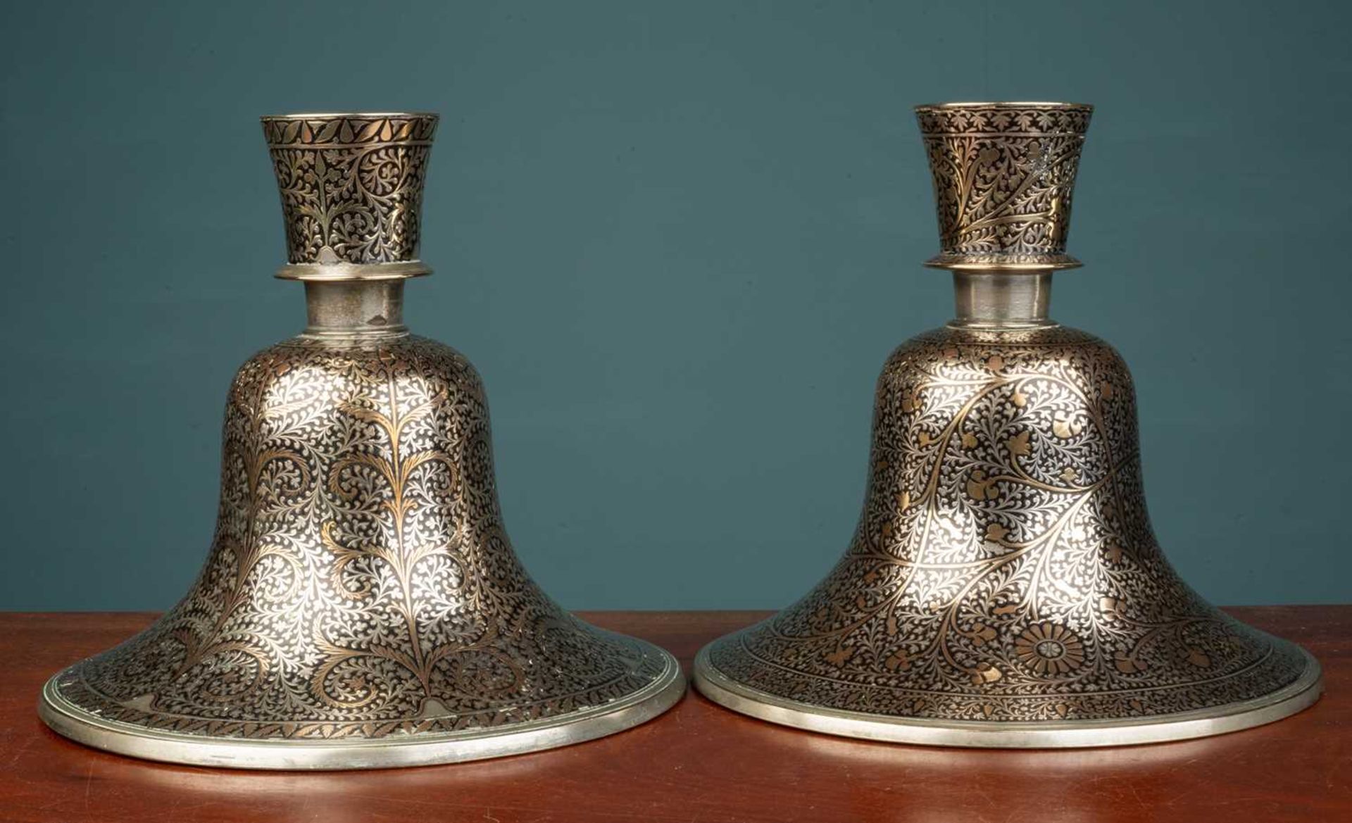 A pair of Indian Mughal style silver and brass inlaid hookah bases