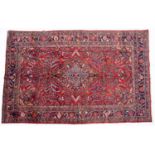 A Middle Eastern Lilihan red ground rug