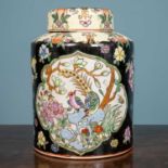 A Chinese famille noire jar, lidded, decorated with flowers, with a red seal mark to the base,