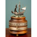A Charles Frodsham Naval table clock or timepiece, surmounted by a white metal ship model, signed