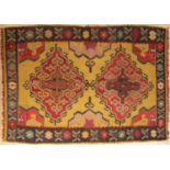 A Turkish flatweave rug, with diamond patterns on a yellow background, purchased in Istanbul,