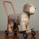 A Lines Brothers (Ireland) Ltd ride on and push along dog, 60cm long x 62cm high overallThe dog with