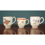 Three different porcelain cups, decorated with floral designs, one possibly Bow, stamped 'E' to