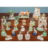 A collection of 19th century and later Staffordshire figurines to include a bull baiting group (