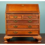 A small 19th century bureau, mahogany, with brass handles on either side, two small and three larger