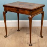 A George II / George III walnut side table with cross banded top, frieze drawer and turned