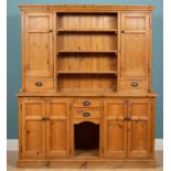 A large pine dresser, with bottom and top cabinets and two small front drawers and three shelves,