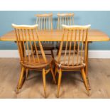 An Ercol light elm kitchen table together with four Ercol chairs to match, the table 53cm long x