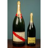 One large display GH Mumm et Cie champagne bottle together with one smaller Joseph Perrier champagne