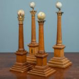 A group of four similar Masonic globe holders, on wooden stepped bases, varying heights from 40 to