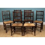 A set of eight spindle black North Country chairs, with rush seats, 48vm w x 40cm d x 94cm hUsed
