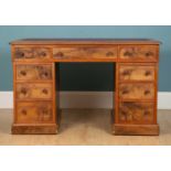 A Victorian walnut pedestal desk with leatherette inset top and turned kob handles, 119cm wide x
