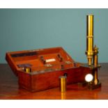 A Zeiss Jena brass microscope, in a mahogany wooden box, with a small box of microscopic glass