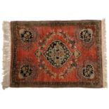 A silk Persian rug, rose pink, 86cm h x 57cm wUsed condition.