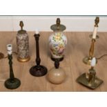 A collection of seven various table lamps, including one with a white porcelain or glass vase