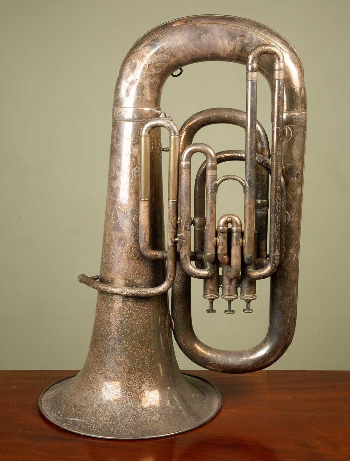 A silver plated Superior Class Hawkes & Son tuba, lacking mouthpiece, with wear to the silver