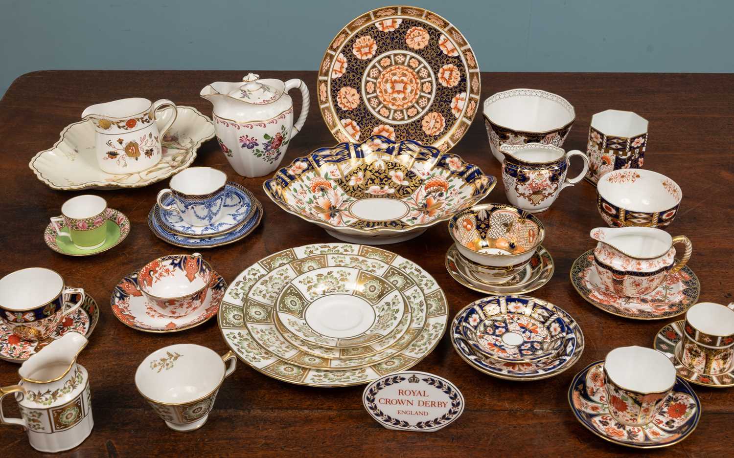 A collection of Royal Crown Derby porcelain to include Imari patterned cups and saucers, three sugar