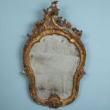 A Rococco style gilt framed wall mirror, distressed, 97 x 54cmUsed condition.