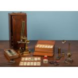 A collection of scientific instruments and other items, comprising of a microsope, two wooden