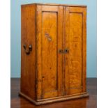 A Victorian oak microscope case, with two panelled doors and carrying handles to the side, 31cm wide