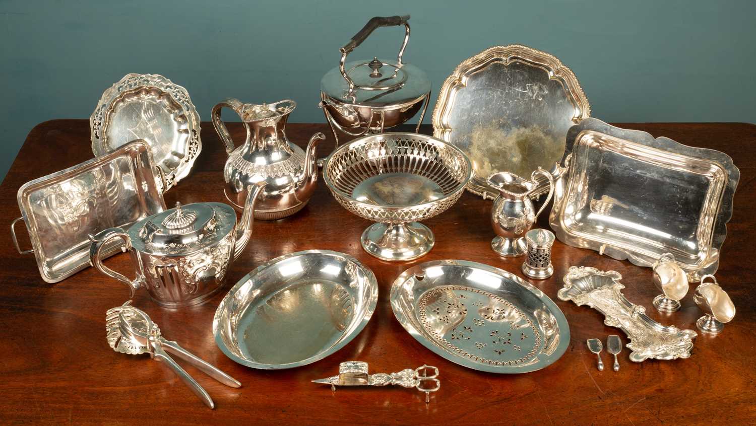 A quantity of silver plated items, to include a tea kettle and stand; a pierced basket; two teapots;