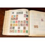 A stamp album containing 19th century and later British and world stamps