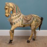 A carved and painted wooden fairground-style horse