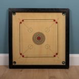 A carrom board and pieces