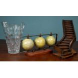 A hardwood staircase model; a set of three globes; and a glass vase