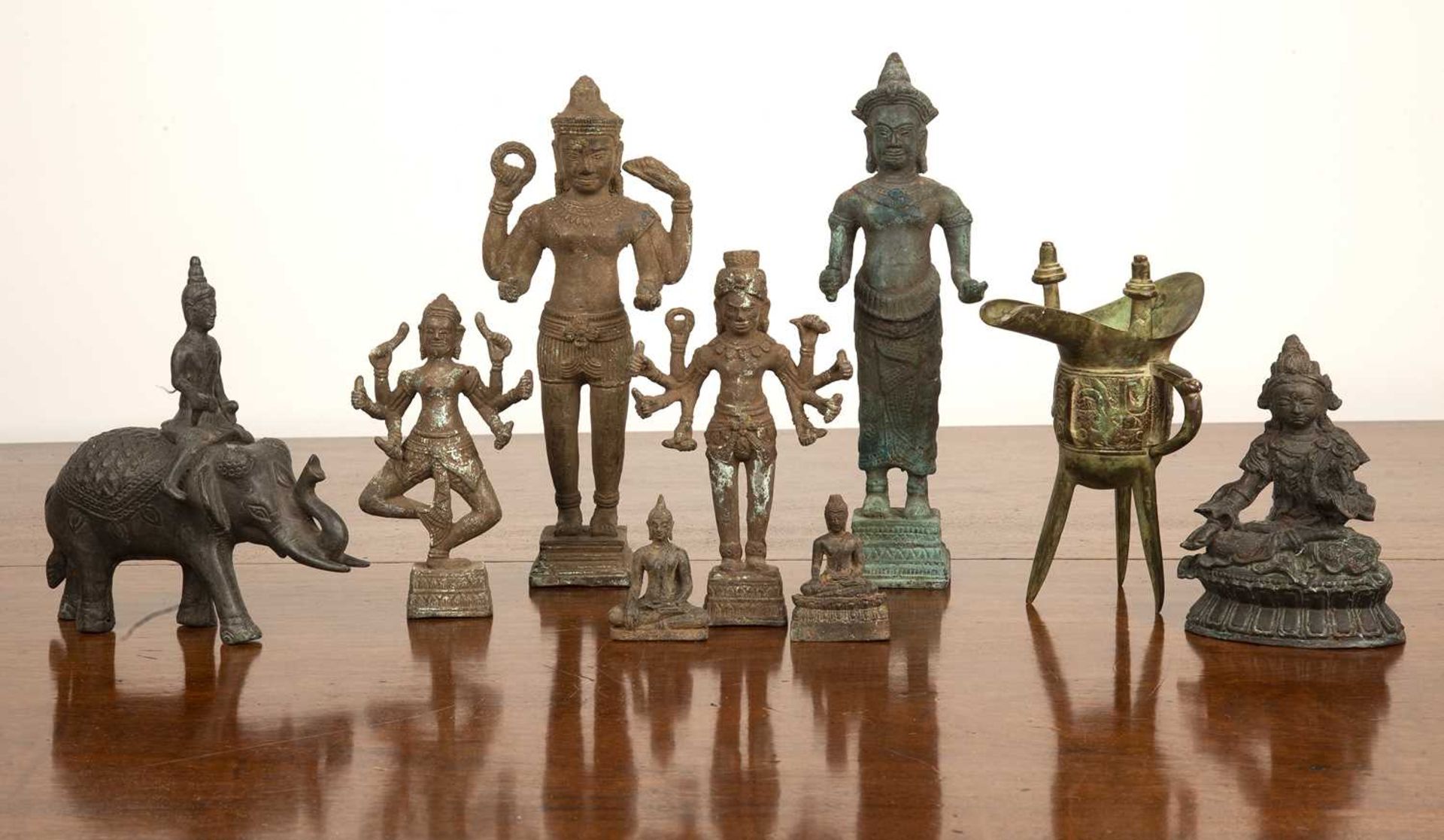 Nine Chinese cast metal figures after the originals, to include a Jue vessel and other objects, (9)