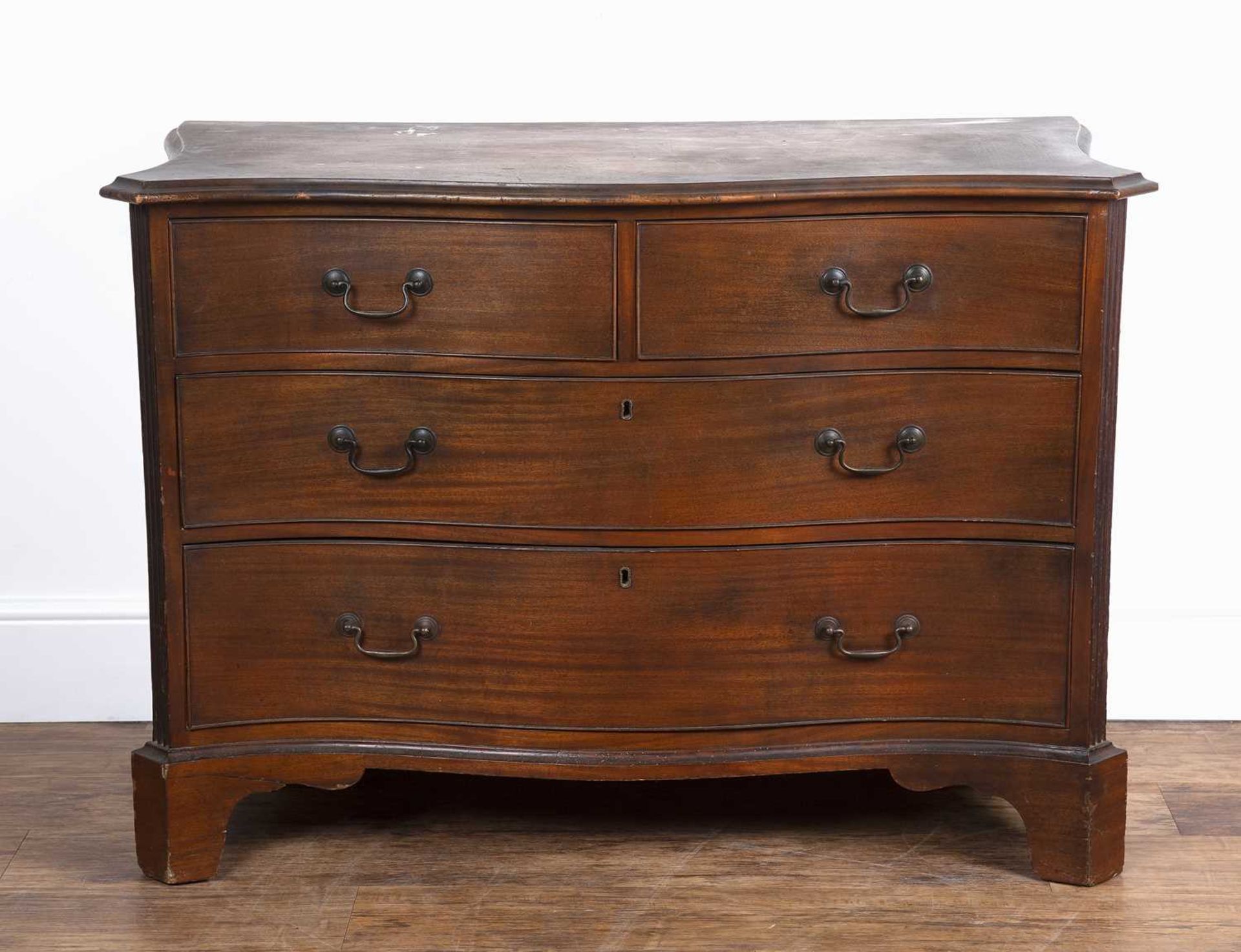 Mahogany serpentine chest 19th Century, fitted three drawers with brass handles and fluted sides,