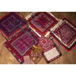 Group of mirrored textiles probably Indian, all of similar decoration in bright purple colours,
