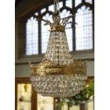 Glass and gilt metal classical-style chandelier of pear-shape proportion with classical leaf mounts,