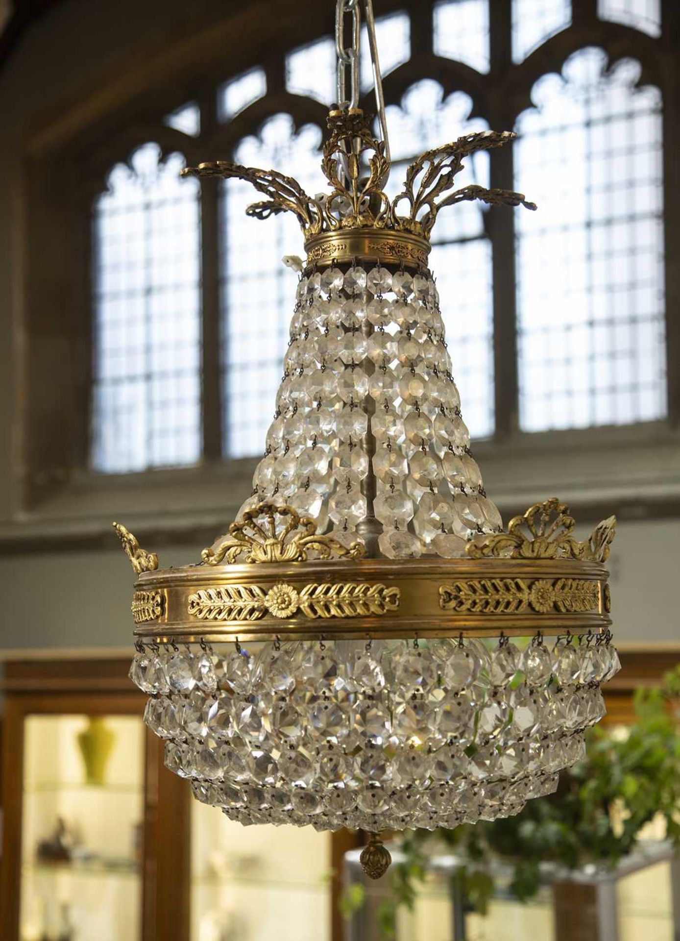 Glass and gilt metal classical-style chandelier of pear-shape proportion with classical leaf mounts,