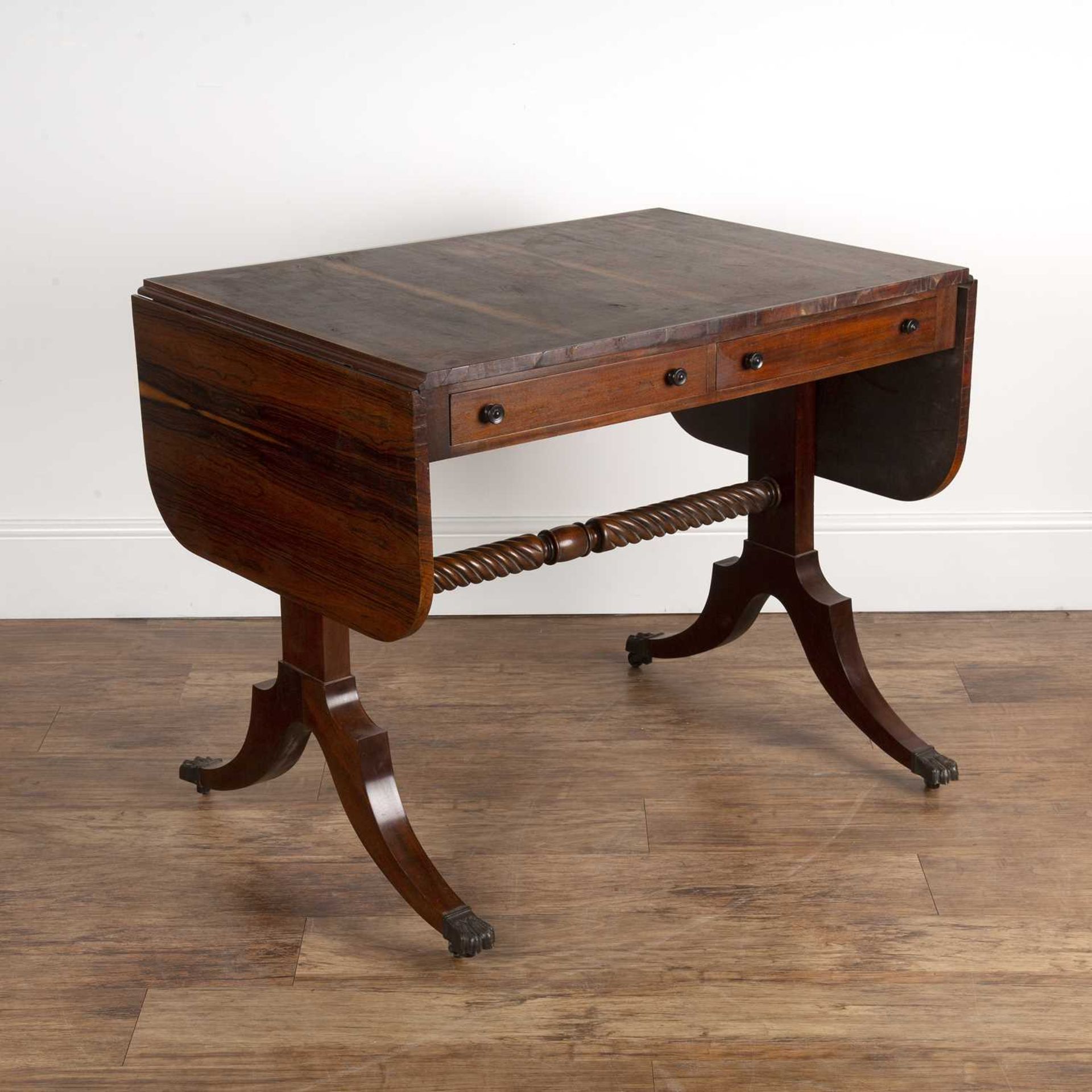 Rosewood veneered and mahogany sofa table in the Regency style, fitted two drawers with ring