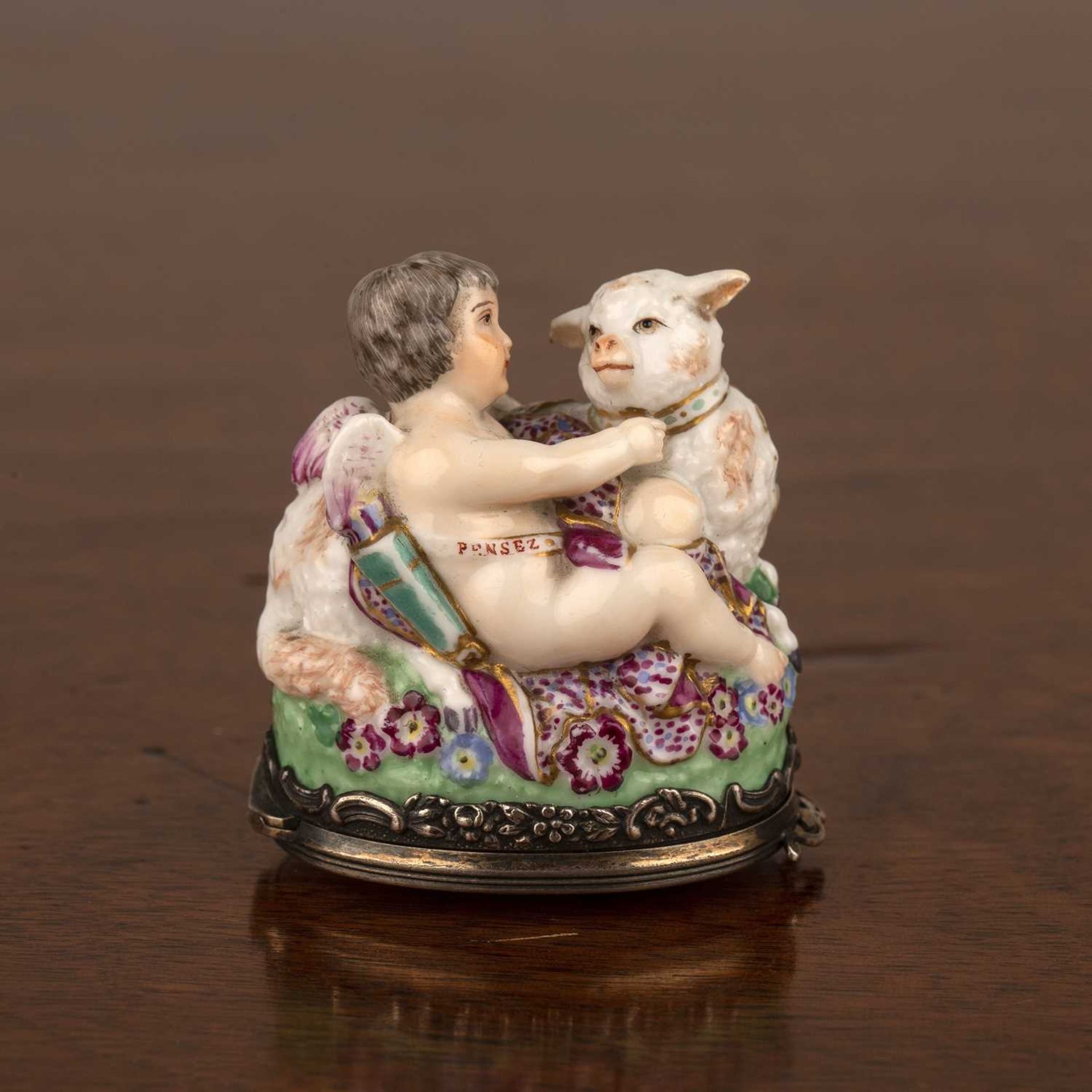 Porcelain bonbonierre French, late 19th Century modelled as a cupid and sheep, with silver metal