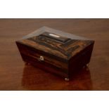 Coromandel sewing box 19th Century, of sarcophagus form with fitted interior on brass ball feet