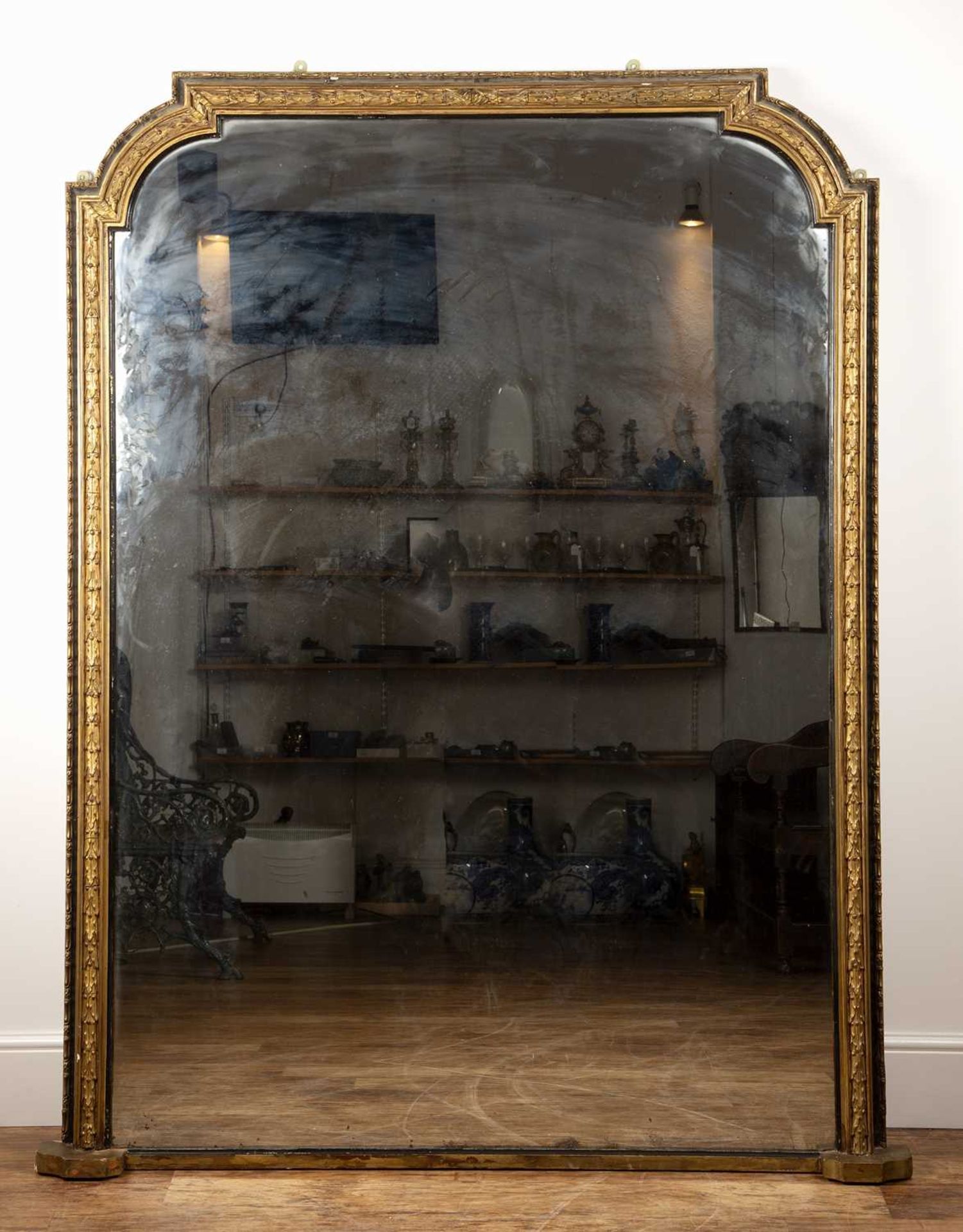 Very large gilt plaster and ebonised overmantel mirror 19th Century, with leaf and ribbon border,