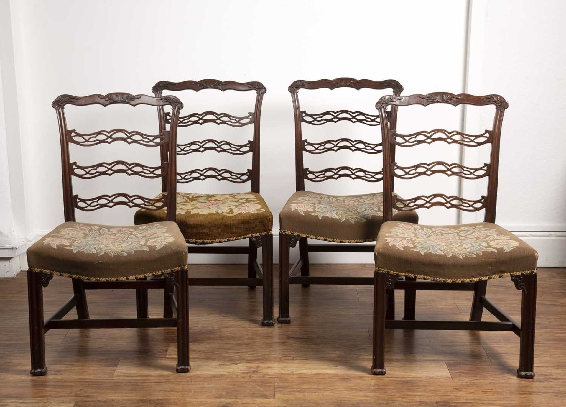 Set of four Chippendale style ladderback dining chairs 18th/19th Century, each with carved
