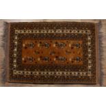 Red ground rug Afghanistan, with elephant foot designs and with a banded border, 186cm x 127cmWith