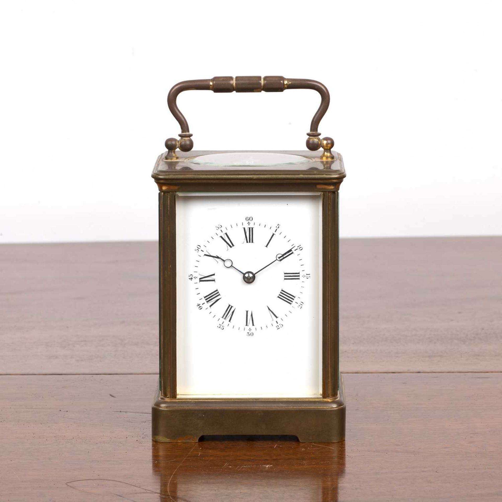 French eight-day brass carriage clock with key the white enamel dial with black Roman numerals,