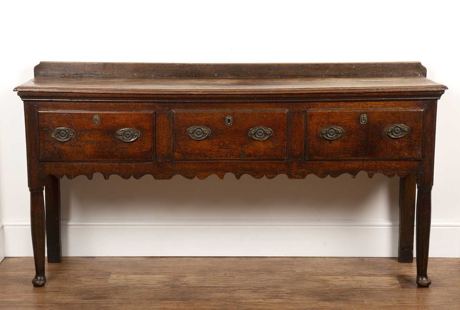 Oak dresser base early 19th Century, fitted with three drawers, on raised pad feet, 169cm wide x