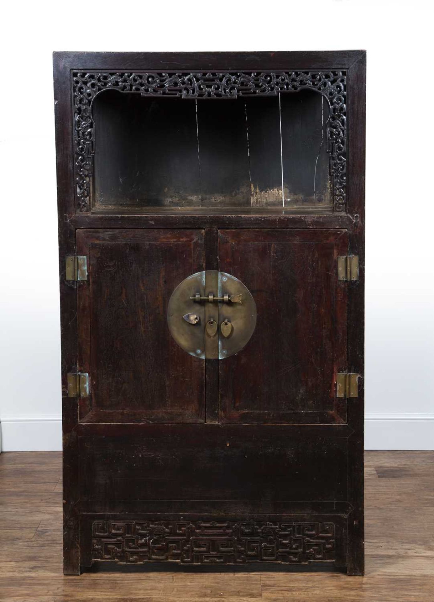 Stained wood cupboard Chinese, early 20th Century, with open top with carved surround and with