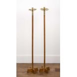 A pair of oak and brass tall floor standing candle stands in the Arts & Crafts style, 118cm high